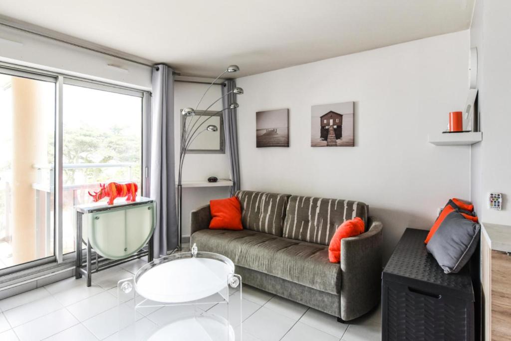 a living room with a couch and a table at Studio 3/4 personnes vue mer - maeva Home - Studio 4 personnes vue mer - Prestige - super Home MAE-2696 in Pornichet