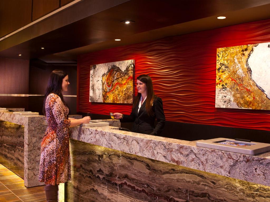 two women standing at a counter in a restaurant at Golden Nugget Biloxi in Biloxi
