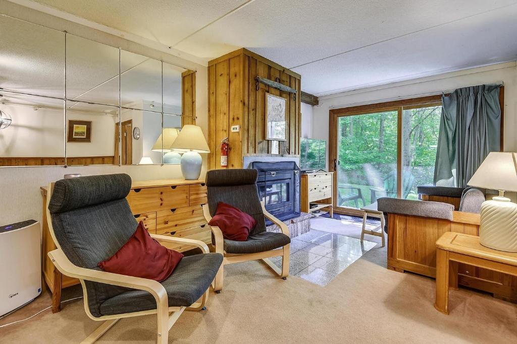 a living room with two chairs and a counter at Whiffletree G1 in Killington