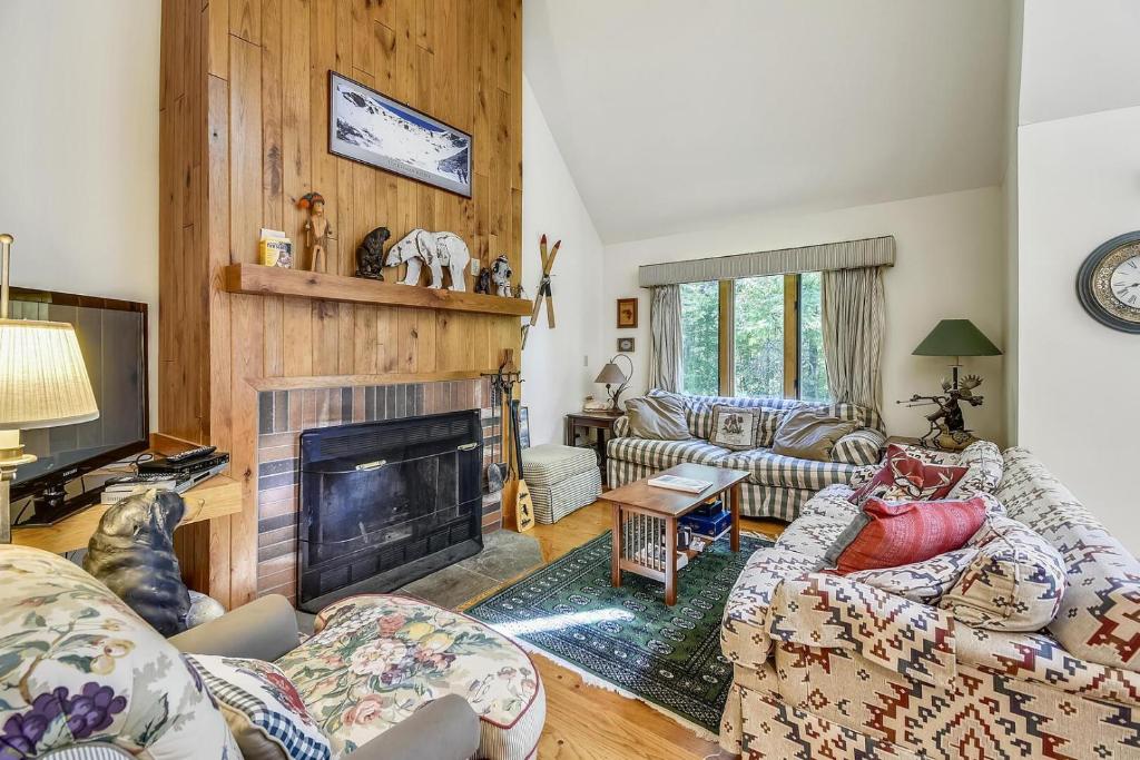 a living room with couches and a fireplace at Colony Club C12 in Killington
