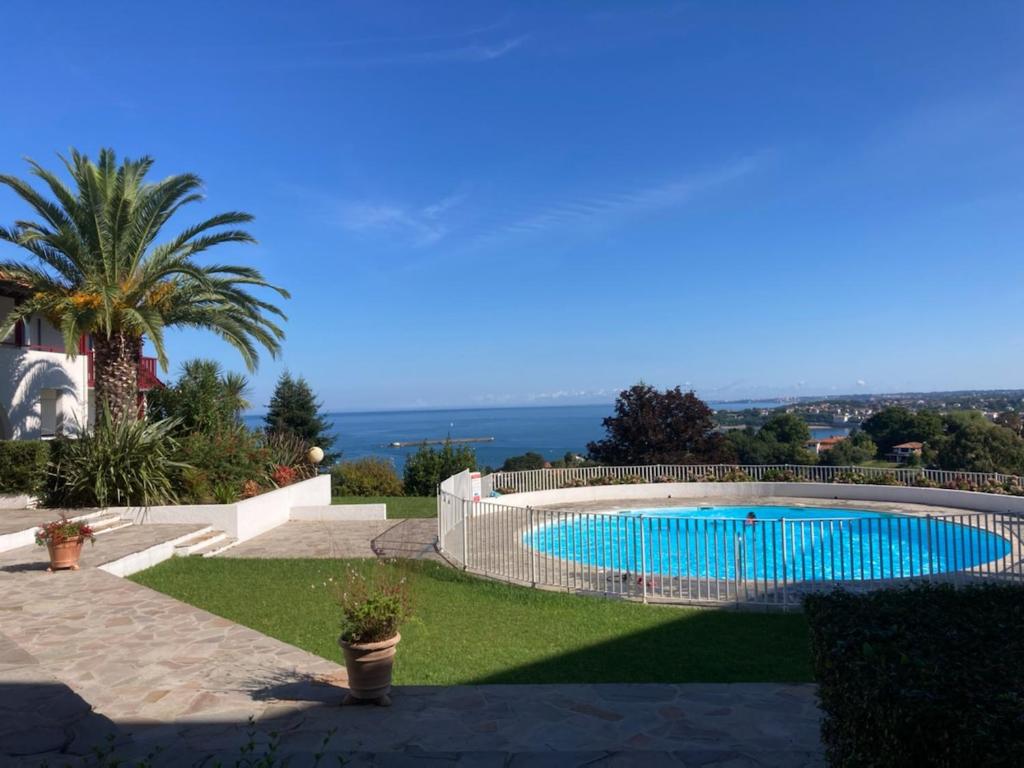 a swimming pool in the middle of a yard at Studio Haut De Bordagain Ciboure in Ciboure