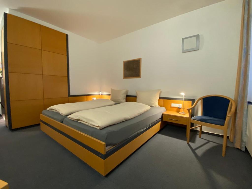 Schlafzimmer mit einem Bett, einem Schreibtisch und einem Stuhl in der Unterkunft Hotel am Stadtpark in Borken