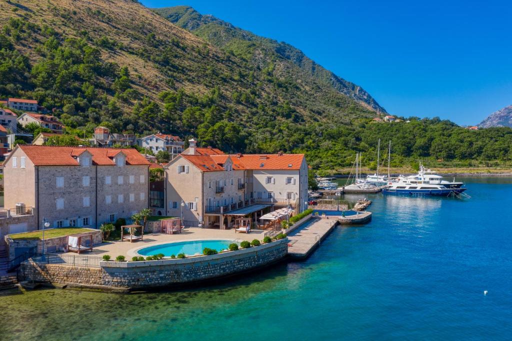 a group of boats docked in a body of water at Hotel Splendido in Kotor