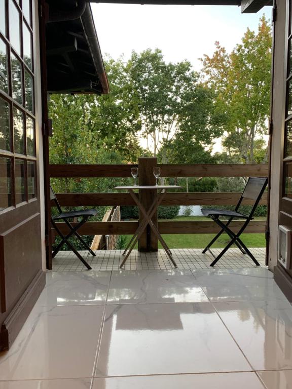 a porch with a bench and a table at Abatilles in Arcachon