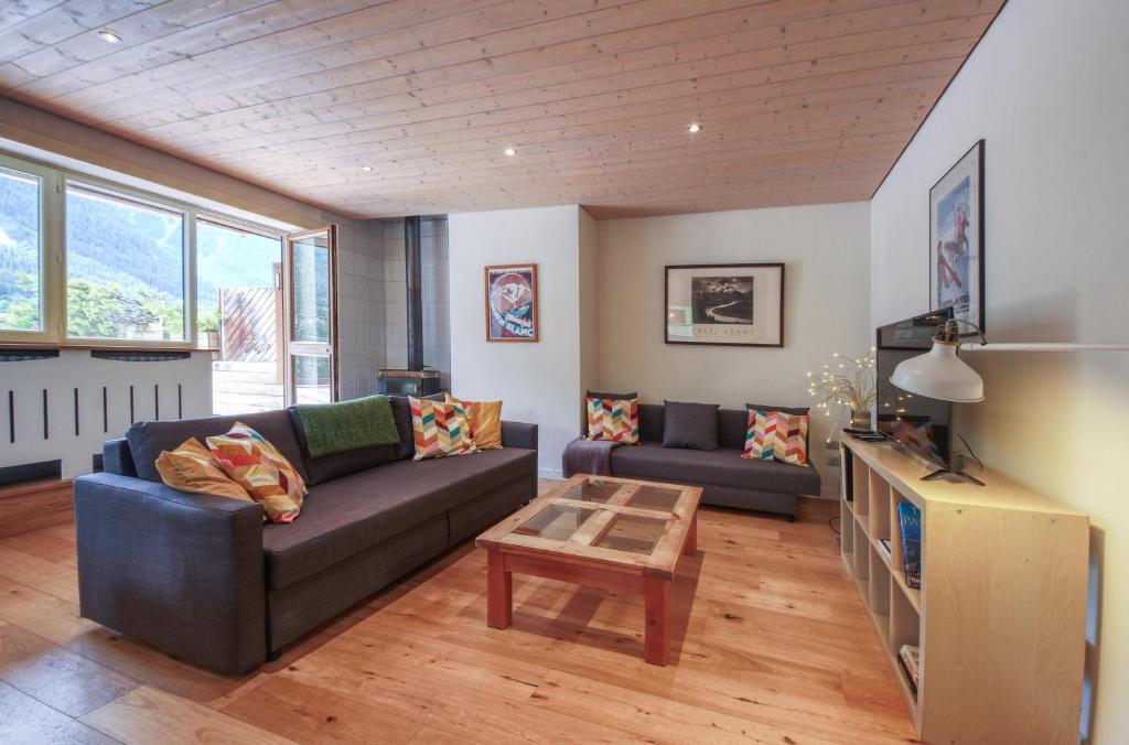 a living room with a couch and a table at Gaillands North in Chamonix