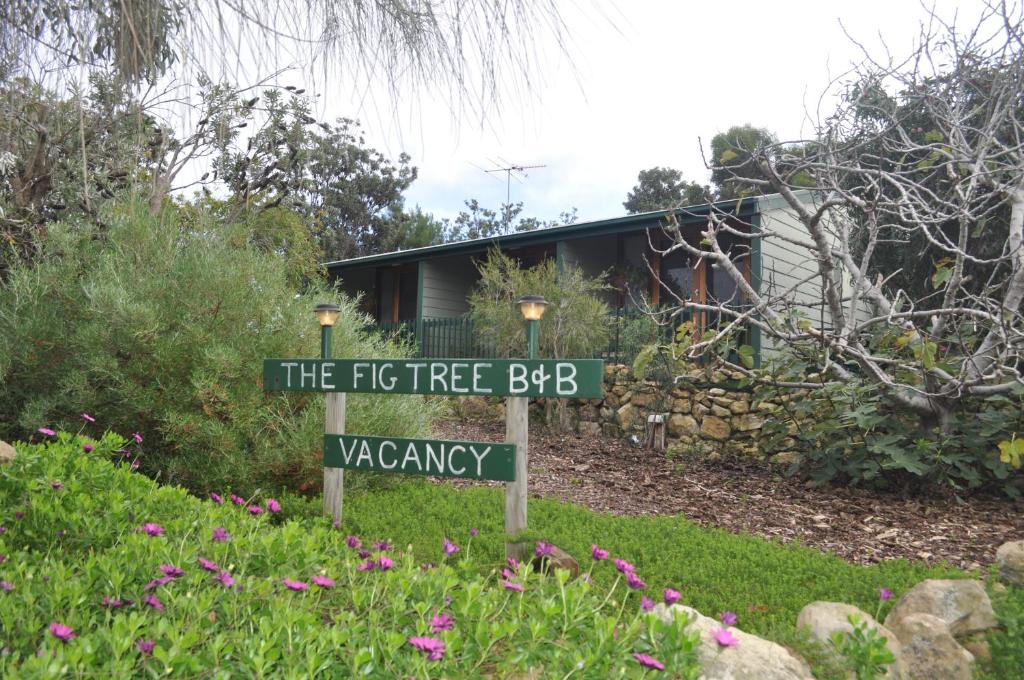 a sign in a yard in front of a house at The Fig Tree B&B in Baudin Beach