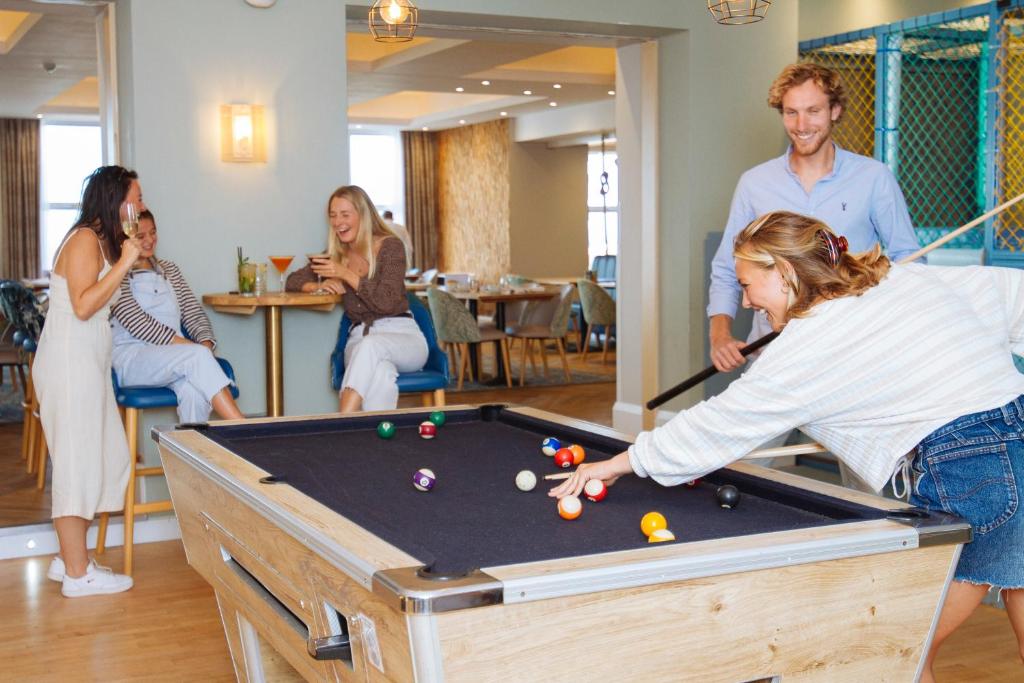 a group of people playing a game of pool at Esplanade Hotel in Newquay