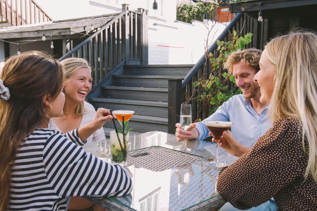 a group of people sitting at a table with wine glasses at Esplanade Hotel in Newquay