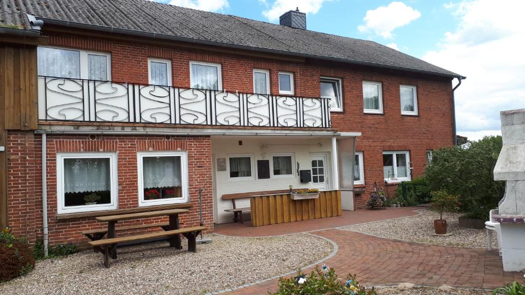 a brick house with a bench in front of it at Seeblick in Hohenfelde