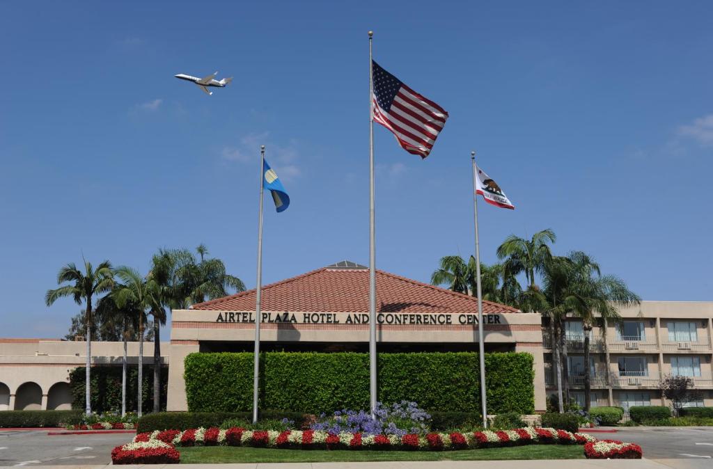 an american trail hotel and convention center with two flags at Airtel Plaza Hotel in Van Nuys