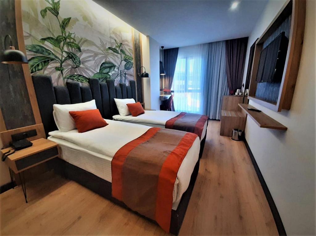 מיטה או מיטות בחדר ב-BURSA KOZA HOTEL