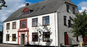 a white building with a black roof at Hotel Viby Kro in Viby