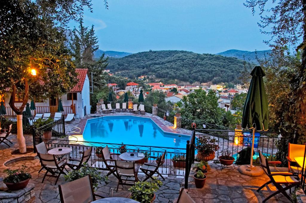 a view of a swimming pool with tables and chairs at Magda's Hotel Apartments in Parga