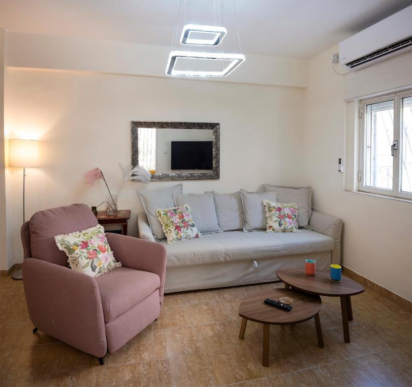 a living room with a couch and a chair at Eyni Lovely Boutique Apartment in Jerusalem
