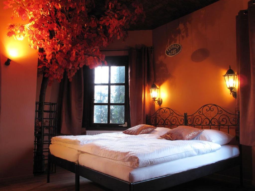 a bedroom with a large bed with a window at Penzion Fermata in Ostrava