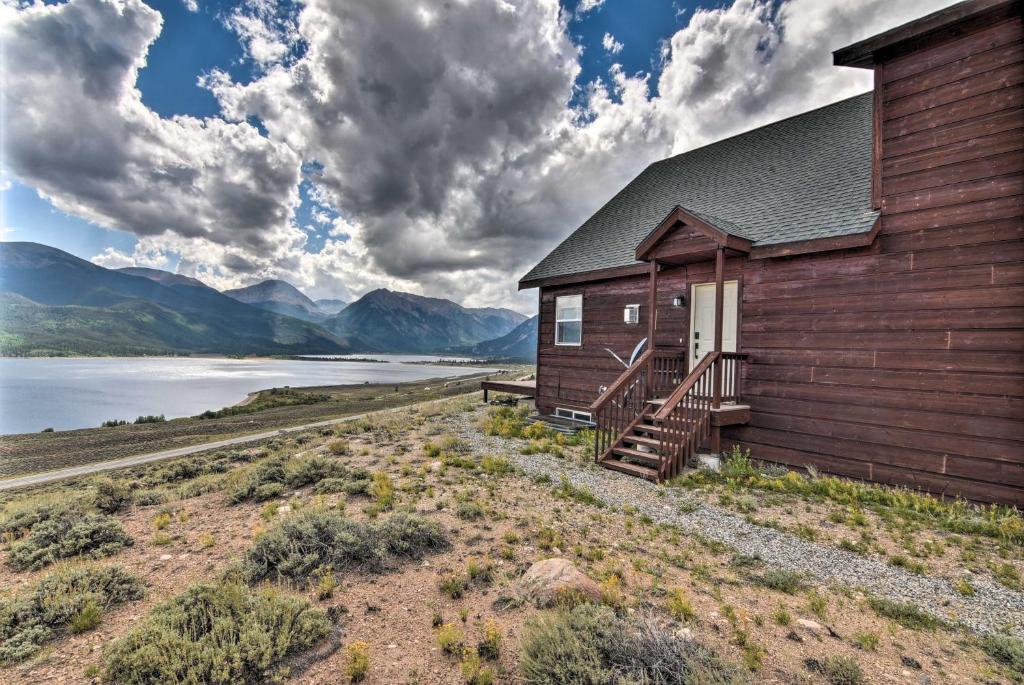 a building with a staircase next to a body of water at Breathtaking Lake-View Retreat with On-Site Hiking! in Twin Lakes