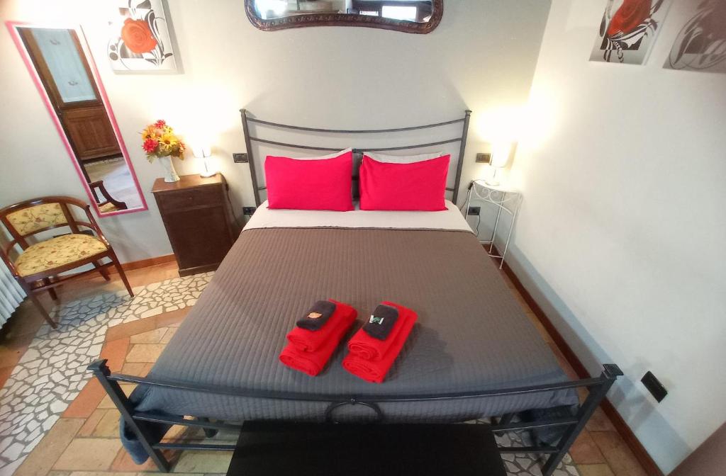 a bedroom with a bed with two red slippers on it at Casa Paola in Spoleto