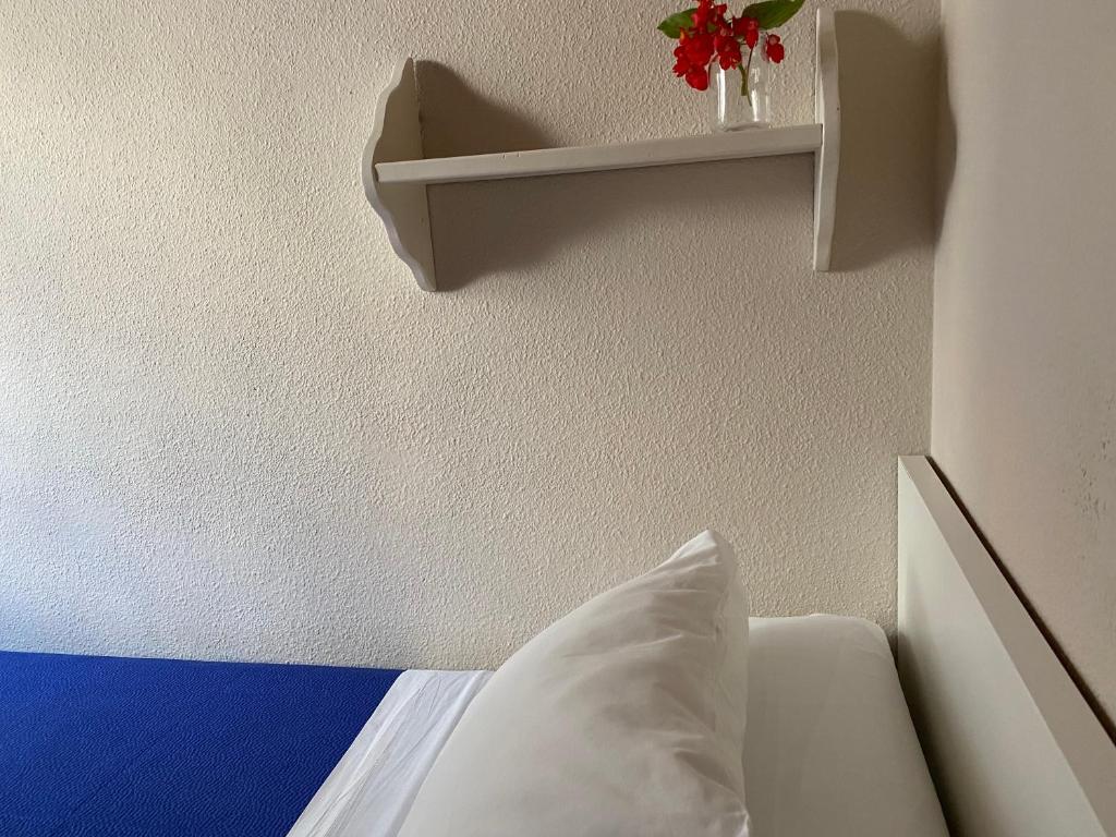 A bed or beds in a room at Hostal Moscatel