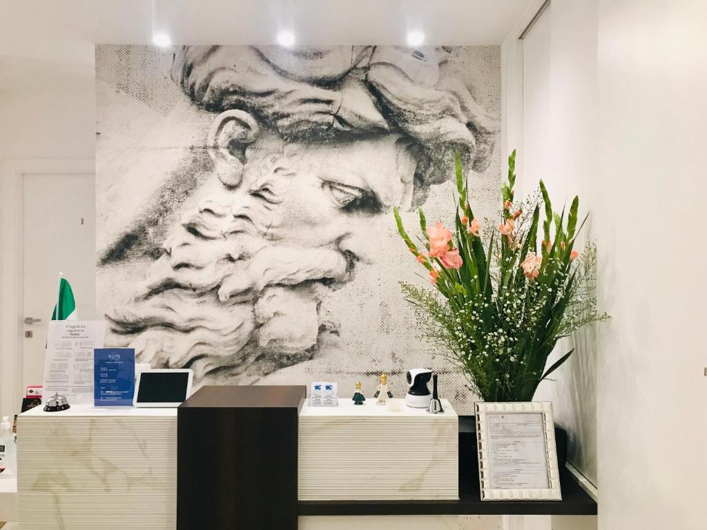 a large painting of a man on a wall at KAMBAL LUXURY SUITES in Rome