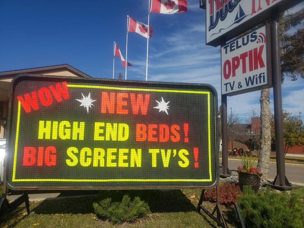 a sign that says new high end beds and big screen tvvs at Dockside Inn in Cold Lake