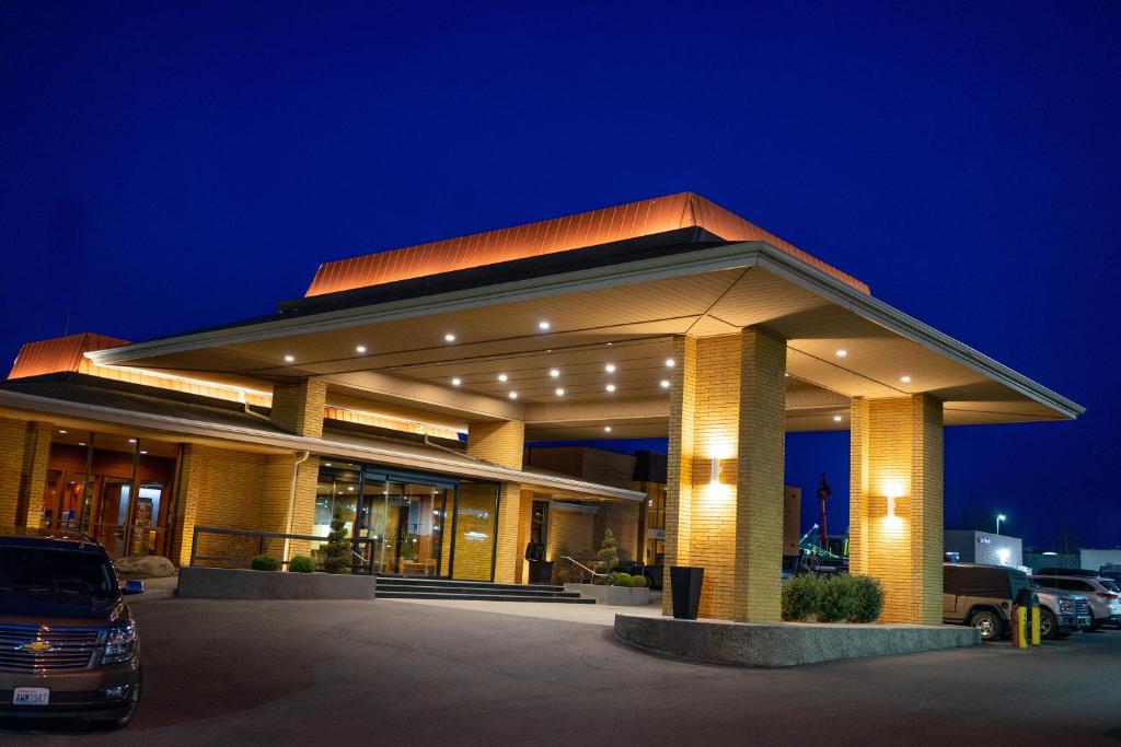 a building with a car parked in a parking lot at Mirabeau Park Hotel in Spokane Valley