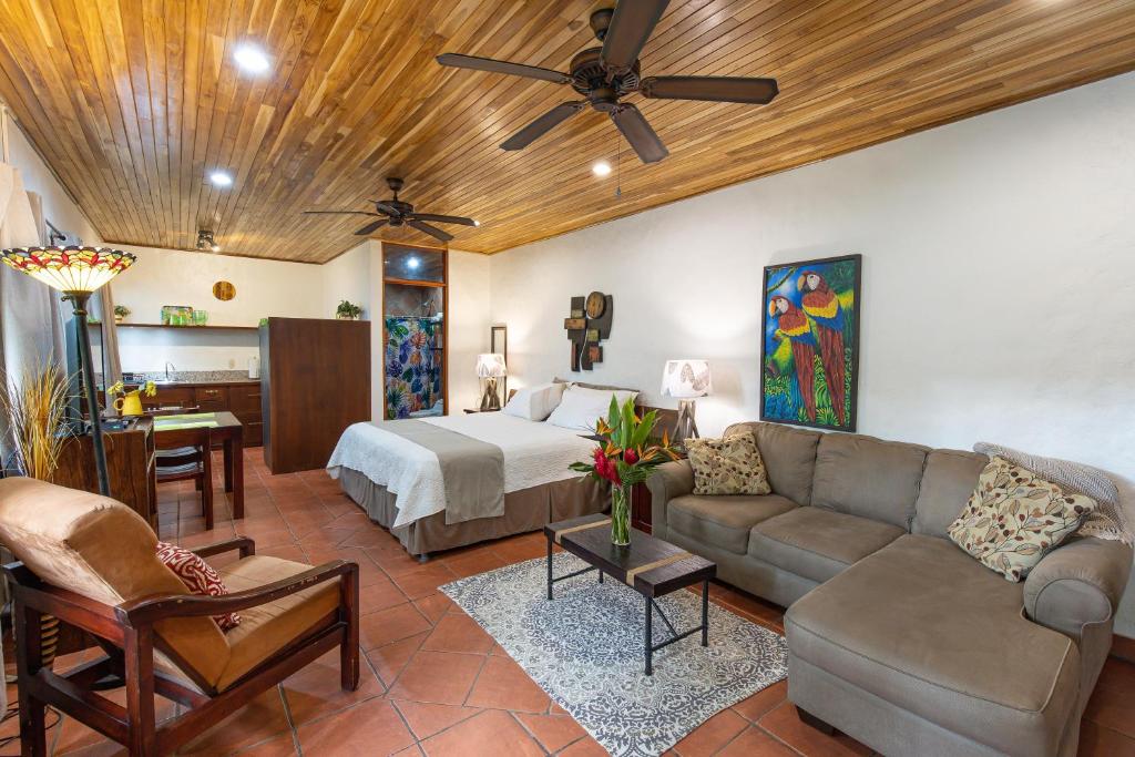 a living room with a bed and a couch at Jungle Creek in Manuel Antonio