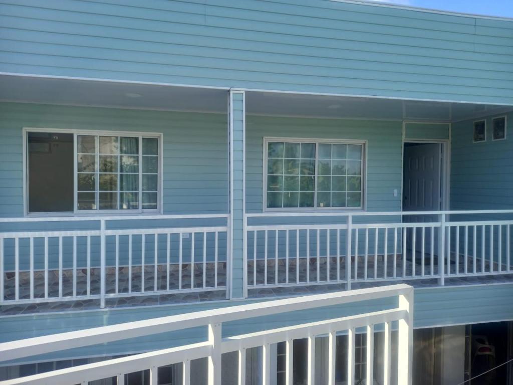 a blue house with a white railing on a balcony at SWEET BREEZE in San Andrés