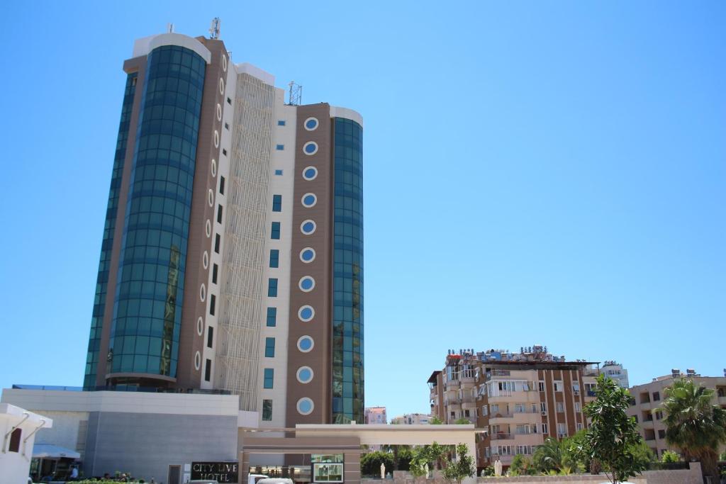 two tall buildings in a city with buildings at City Live Hotel in Antalya