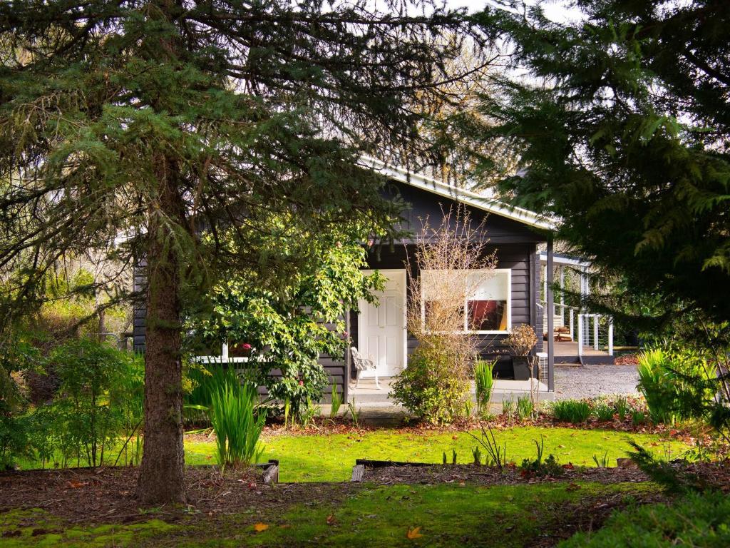 a house with a tree in front of it at The Apple Tree in Hepburn Springs
