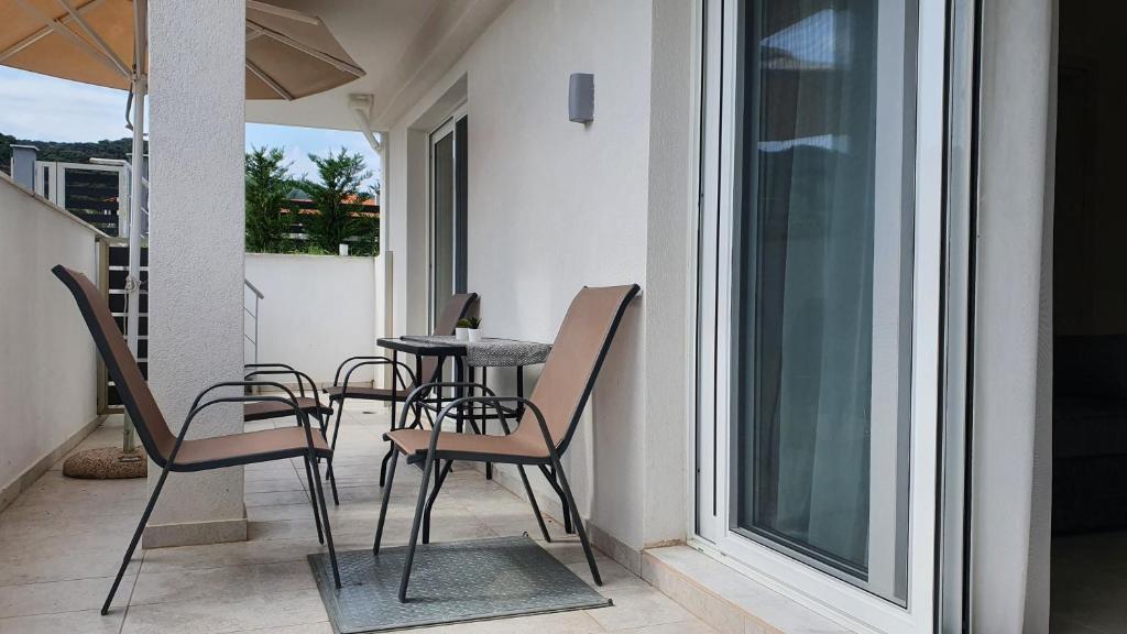 a patio with chairs and a table on a balcony at Astra Sarti Luxury Suites in Sarti