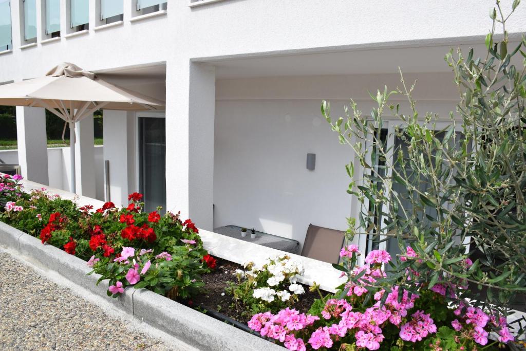 a garden of flowers in front of a building at Astra Sarti Luxury Suites in Sarti
