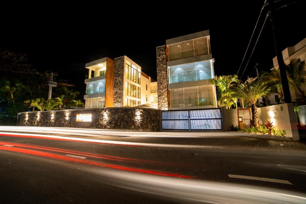 a building with lights in front of a street at night at ONE BAY RESIDENCE NO 8 in Grand Baie