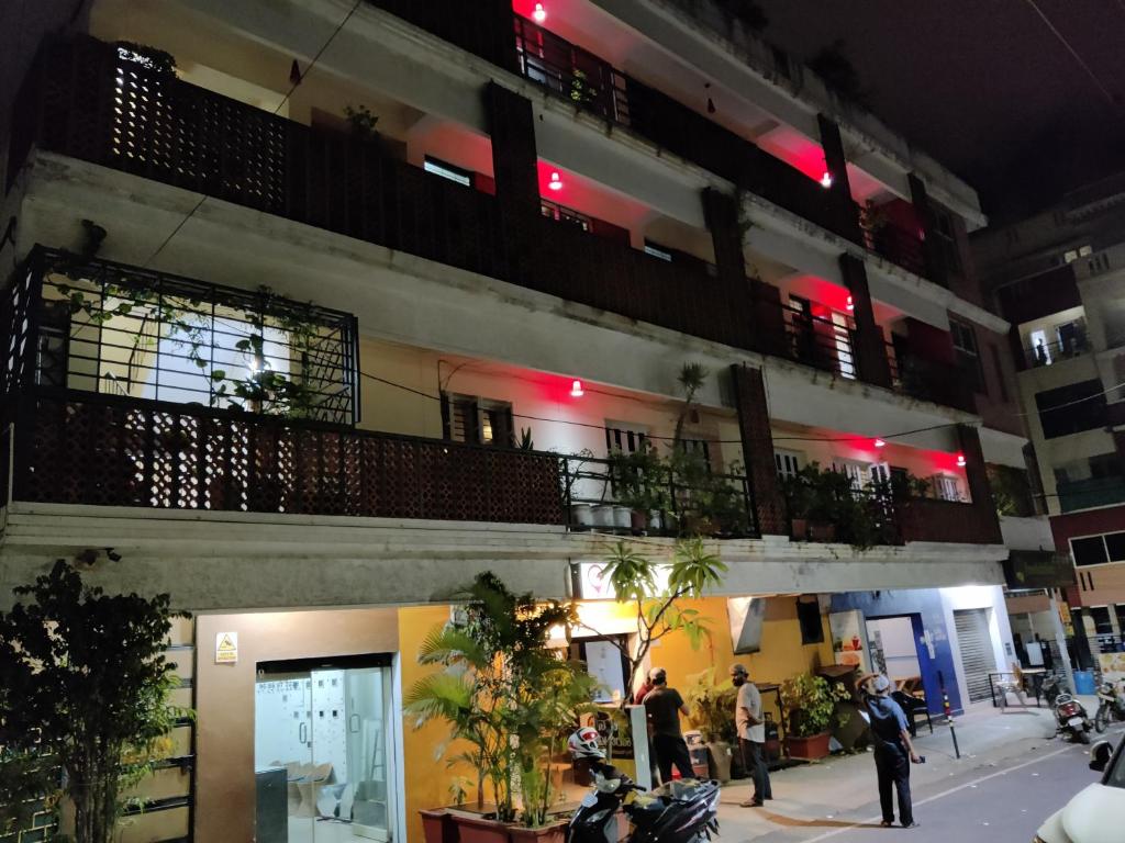 a group of people standing outside of a building at Fernandes Complex in Bangalore