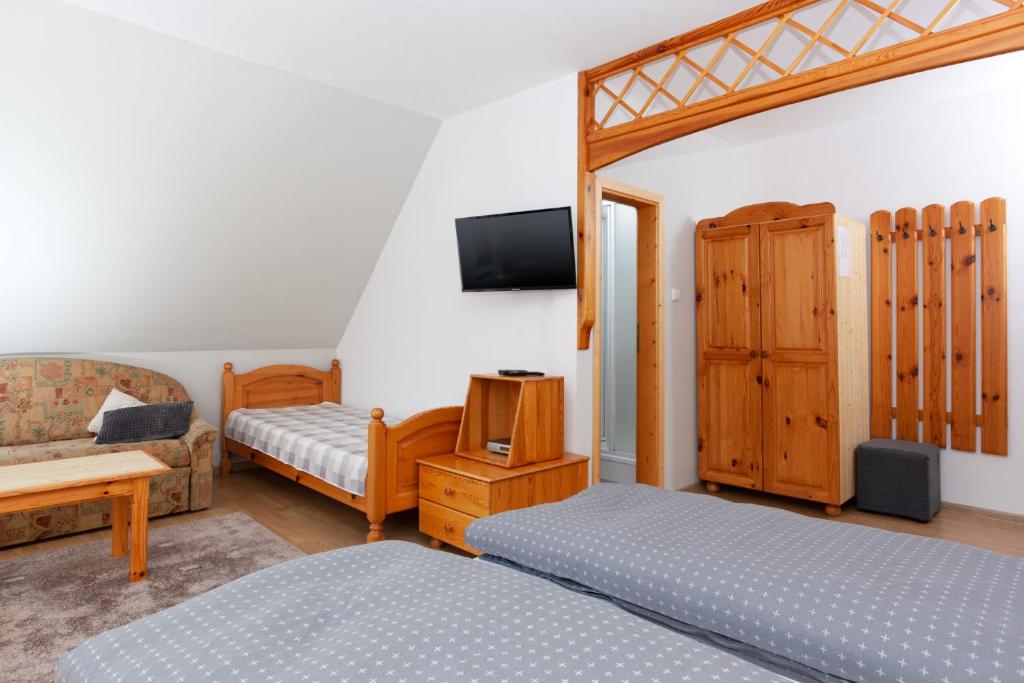 A bed or beds in a room at Penzión Javor