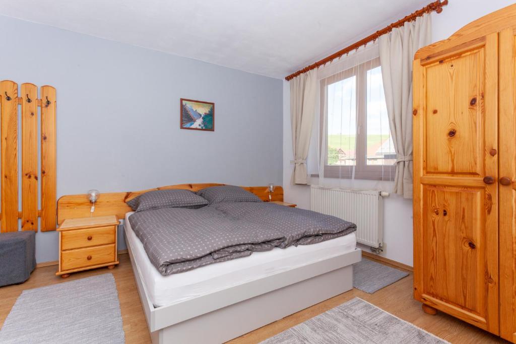 A bed or beds in a room at Penzión Javor