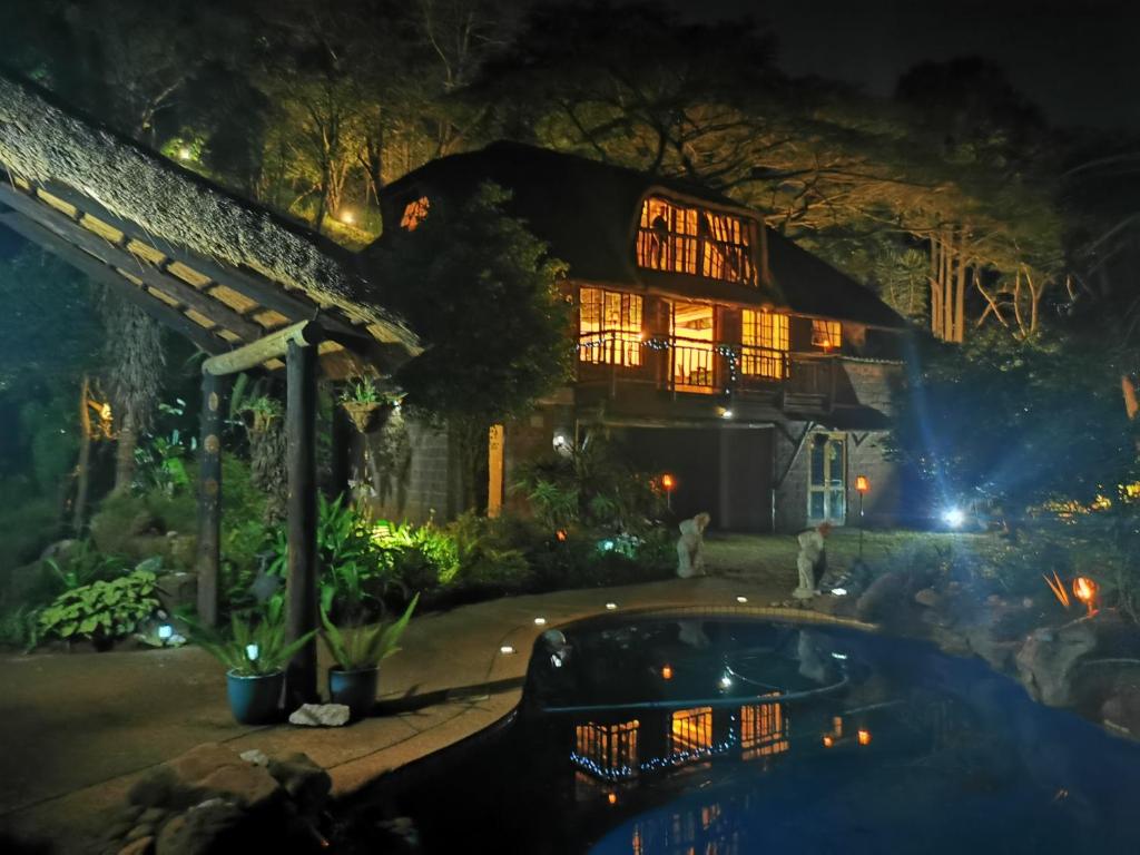 a house at night with a pool in front at Nature Lovers Paradise in Gillitts