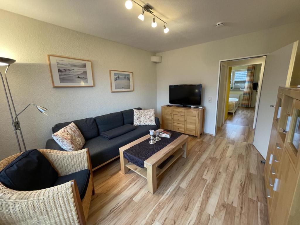 a living room with a couch and a table at Blauer Blick 12 in Laboe