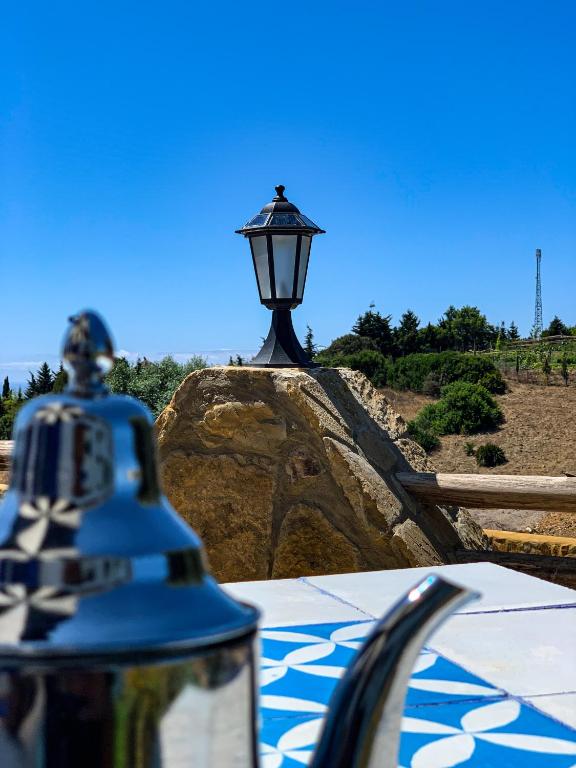 a street light sitting on top of a rock at Dmina House in Asilah