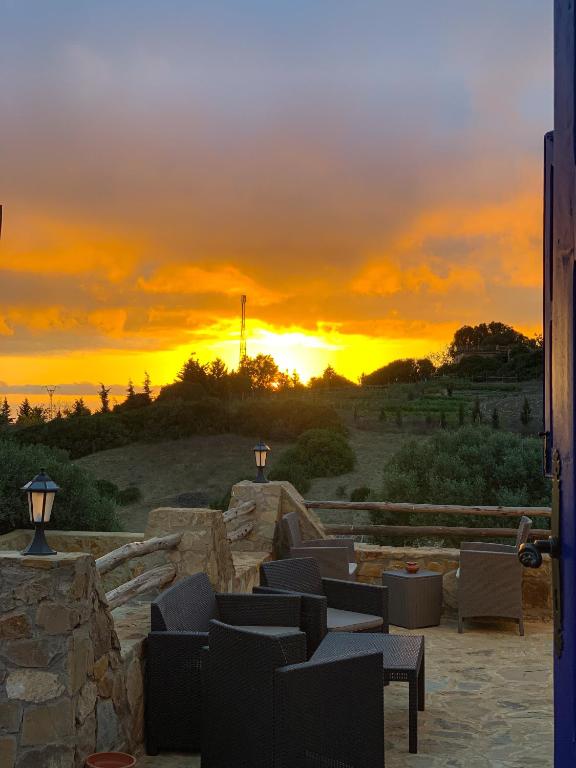 a sunset over a patio with couches and chairs at Dmina House in Asilah