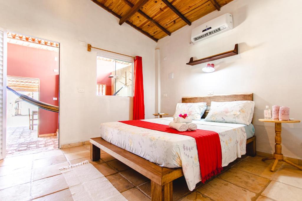 a bedroom with a bed with a red blanket at Abis Beach Suites in Prea