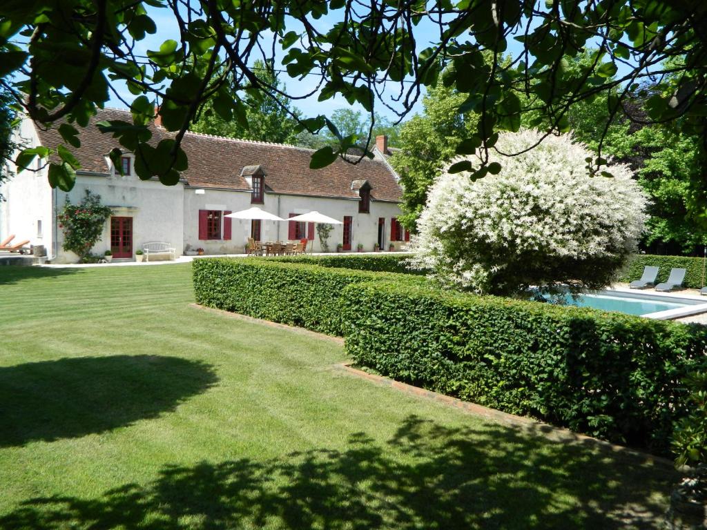 a house with a garden and a swimming pool at Le Bout Du Monde in Villedieu-sur-Indre