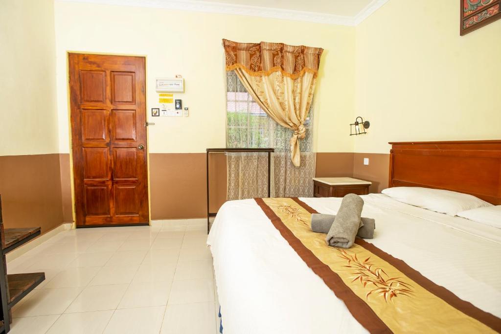 Postel nebo postele na pokoji v ubytování NR Langkawi Motel