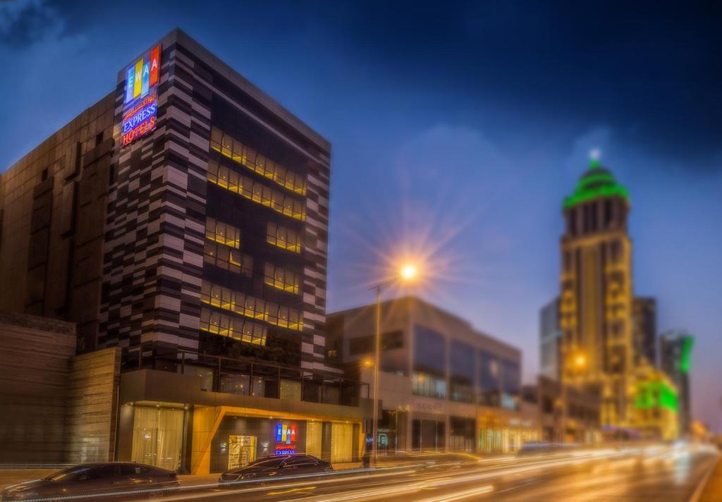 ein hohes Gebäude in der Nacht auf einer Stadtstraße in der Unterkunft Ewaa Express Hotel - Al Olaya in Riad