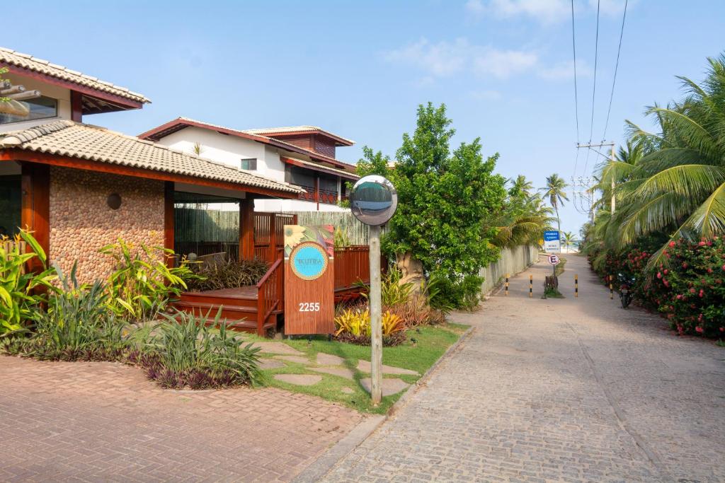 a street with a sign in front of a building at Residencial Ykutiba- Imbassaì Ap A-103 in Imbassai