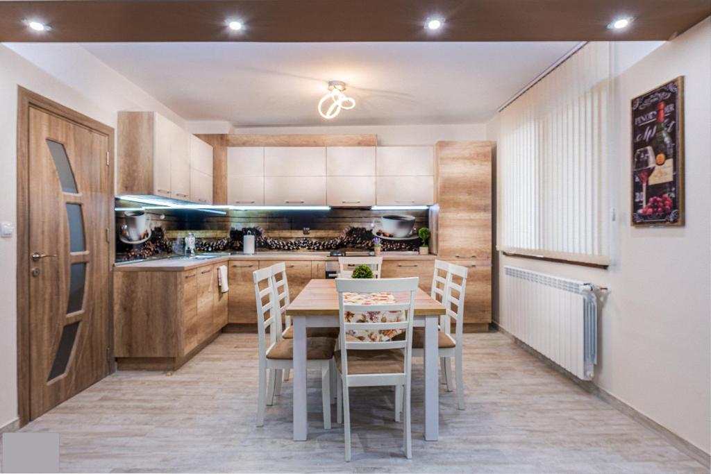 a kitchen and dining room with a table and chairs at Apartment Trayana in Stara Zagora