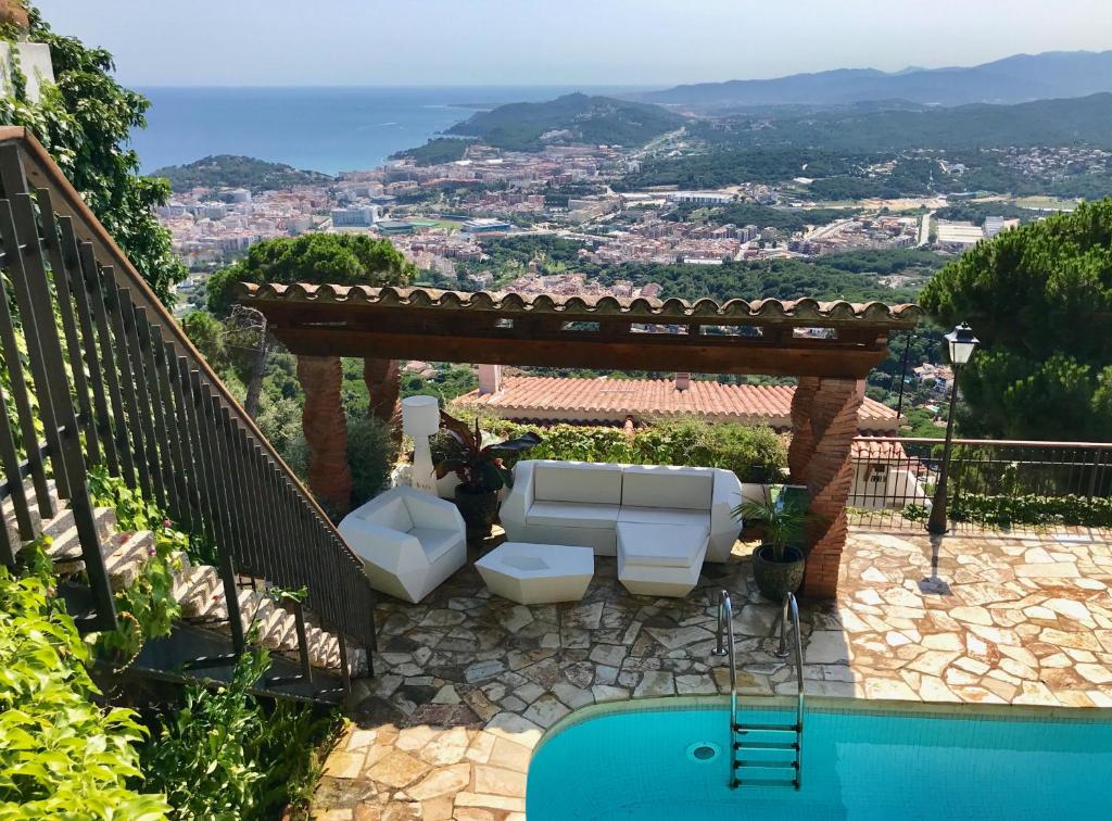 a gazebo with two toilets sitting next to a pool at Villa Panorama 360 in Lloret de Mar