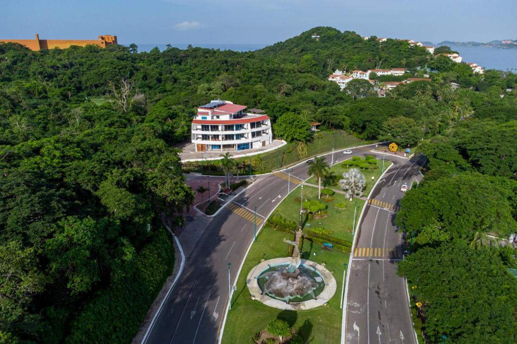 an aerial view of a road with a building at LA LOMA SUITES in Ixtapa