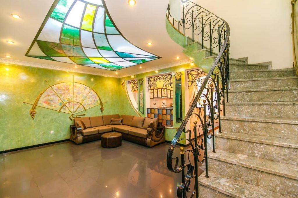 a living room with a couch and a stained glass window at Baku Nizami Street Triplex 4 bedroom in Baku