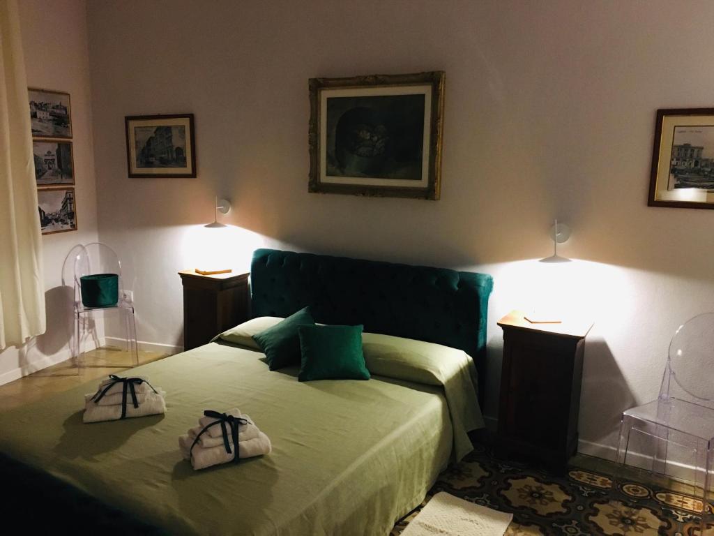 a bedroom with a bed with two bags on it at Antica dimora lamarmora in Cagliari