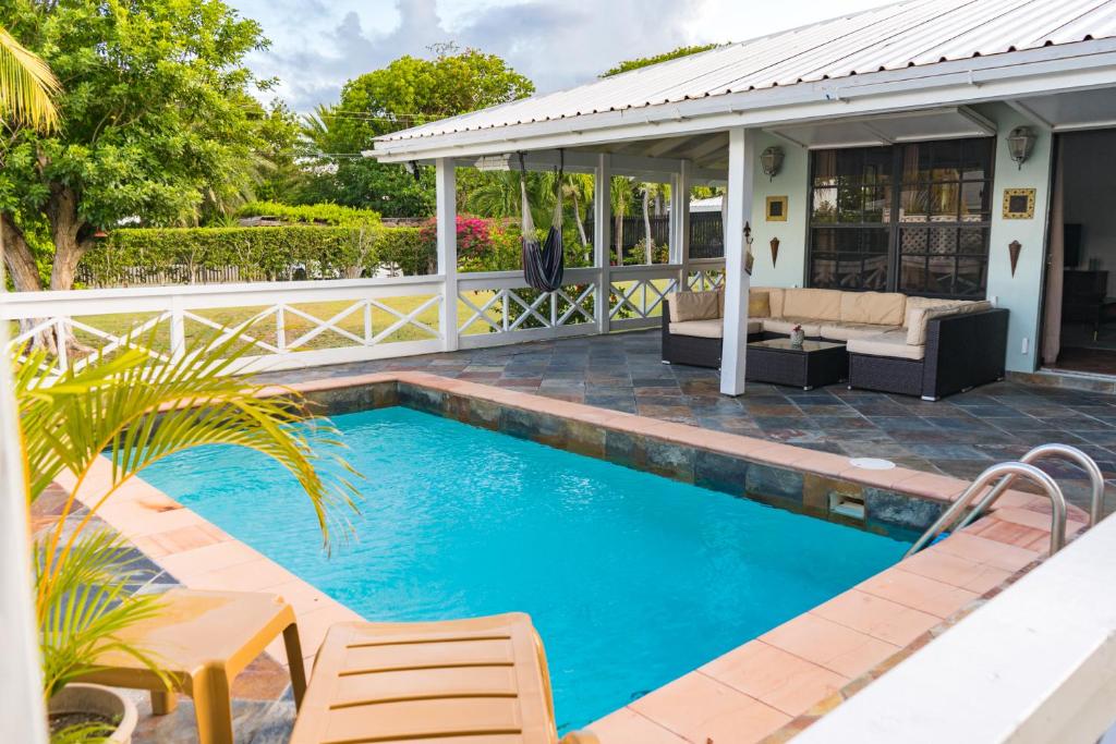 a swimming pool with a patio and a house at Sea Foam Villa in Osbourn